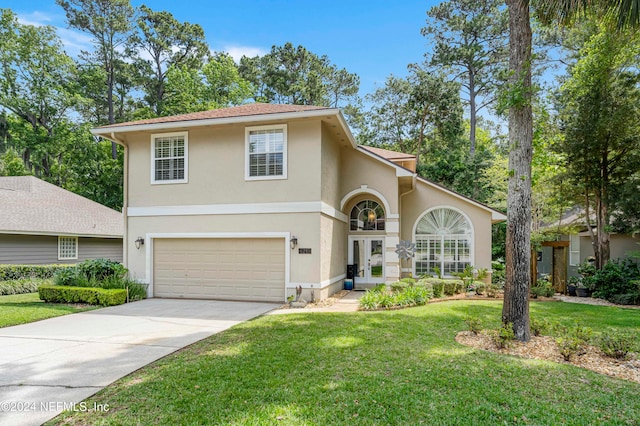 view of front facade with a front yard and a garage