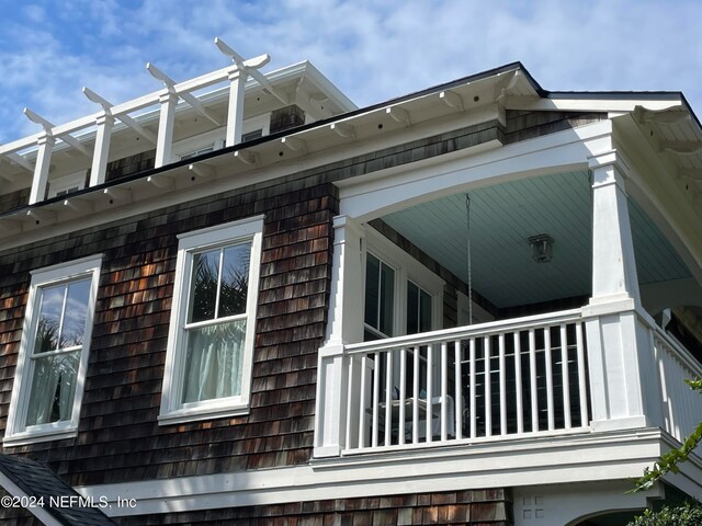 view of side of home featuring a balcony