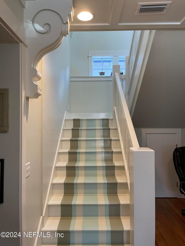 stairway with dark wood-type flooring