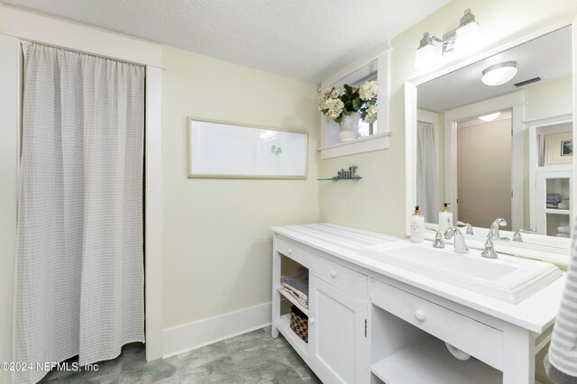 bathroom with oversized vanity and tile floors