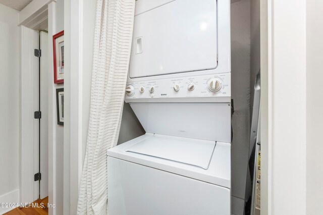 washroom featuring stacked washing maching and dryer