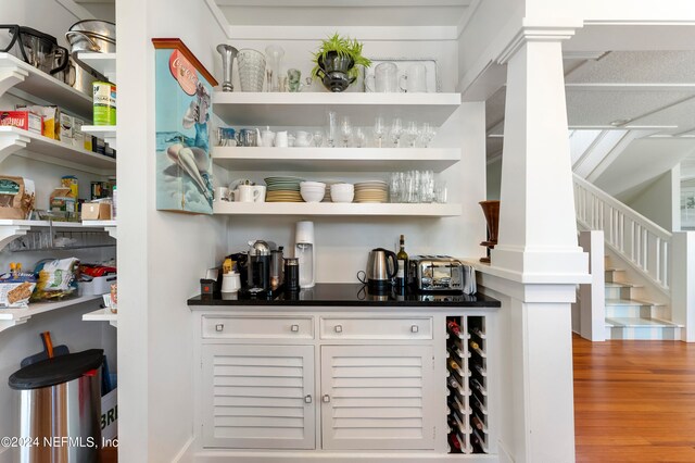 interior space featuring hardwood / wood-style floors and decorative columns