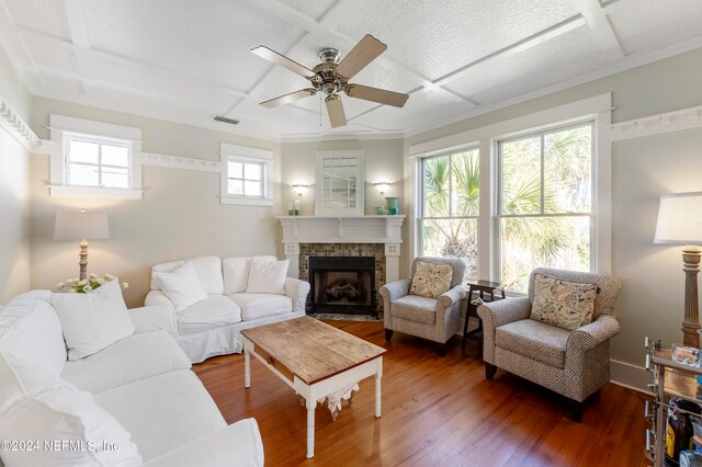 living room with a wealth of natural light, coffered ceiling, ceiling fan, and dark hardwood / wood-style floors