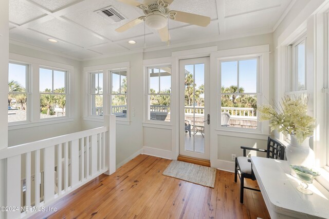 sunroom / solarium featuring coffered ceiling and ceiling fan