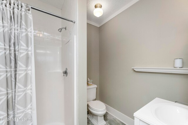 bathroom with curtained shower, toilet, tile flooring, a textured ceiling, and vanity