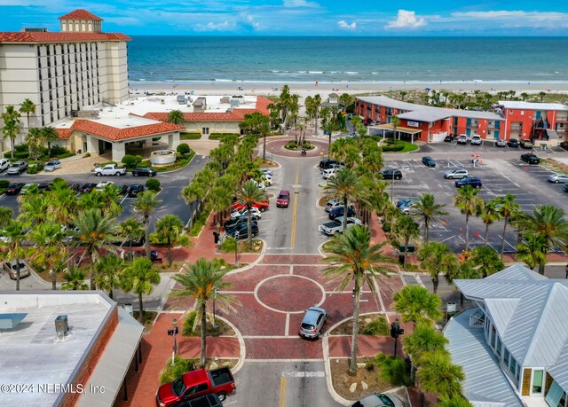 drone / aerial view with a beach view and a water view