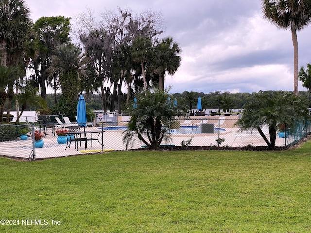 view of pool featuring a lawn and a patio area