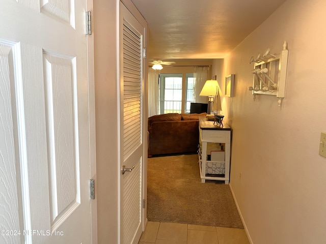 hallway featuring light carpet