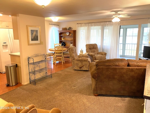 living room with carpet flooring, ceiling fan, and a wealth of natural light