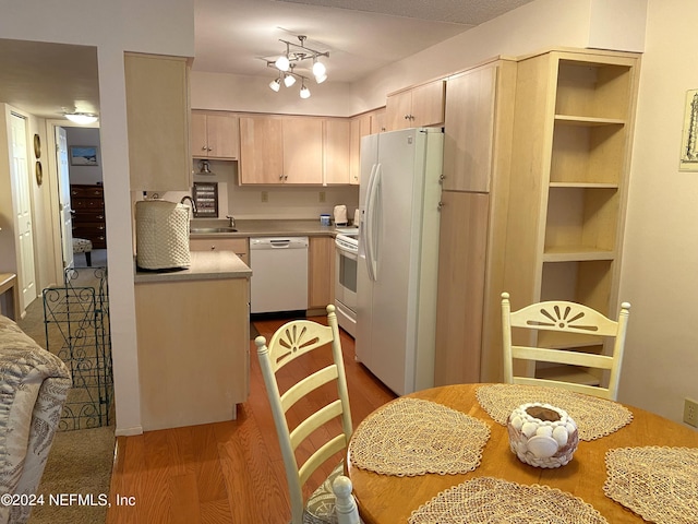 kitchen featuring white appliances, sink, light hardwood / wood-style floors, track lighting, and light brown cabinets