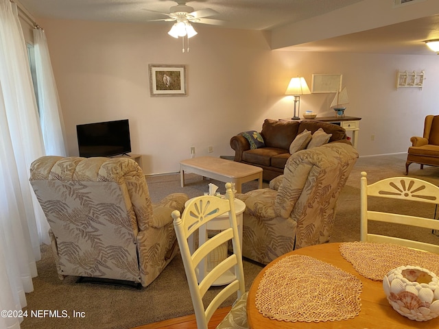 living room featuring ceiling fan and light colored carpet