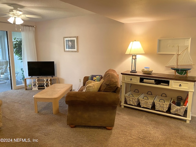 carpeted living room with ceiling fan