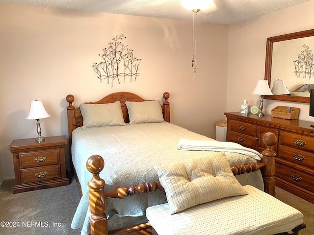 carpeted bedroom featuring a textured ceiling