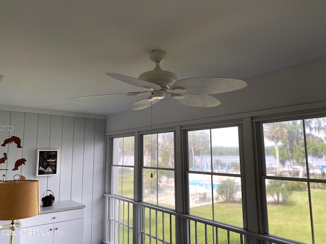 interior details with wood walls and ceiling fan