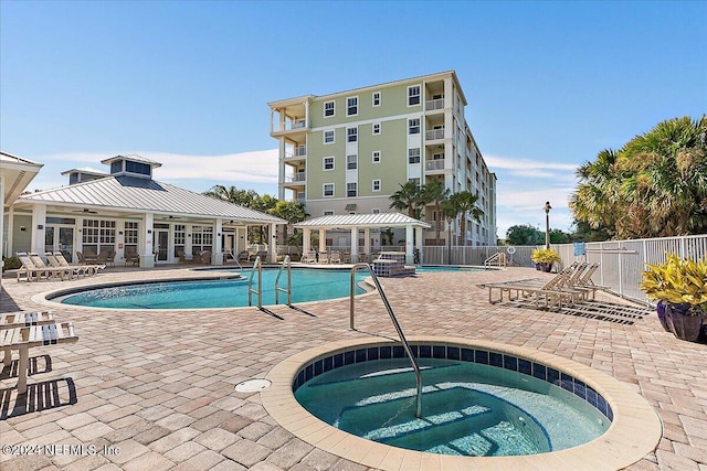 pool featuring a patio, a community hot tub, fence, a gazebo, and french doors