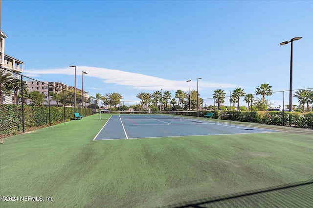 view of sport court featuring fence