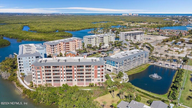 birds eye view of property with a water view and a city view