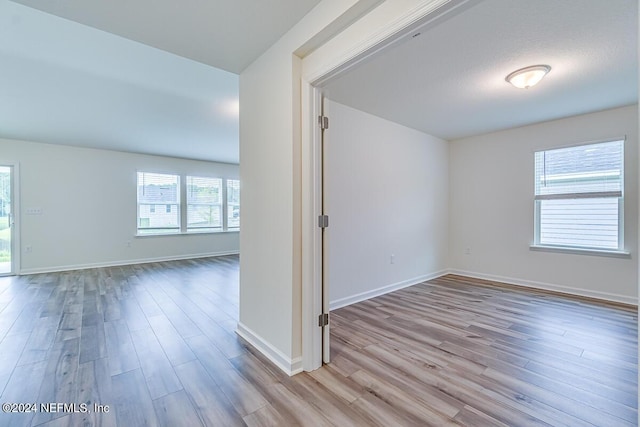 empty room with light hardwood / wood-style flooring