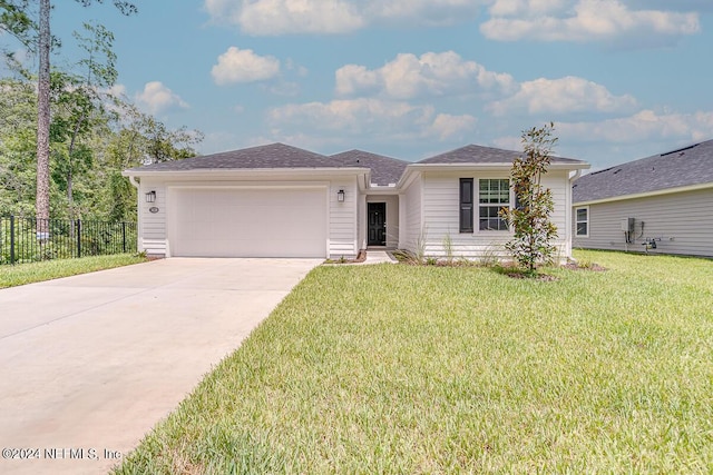 ranch-style home featuring a garage and a front lawn