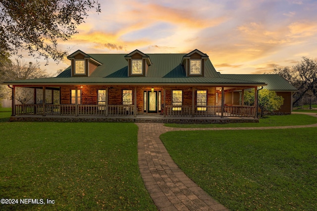 view of front facade with a yard and covered porch