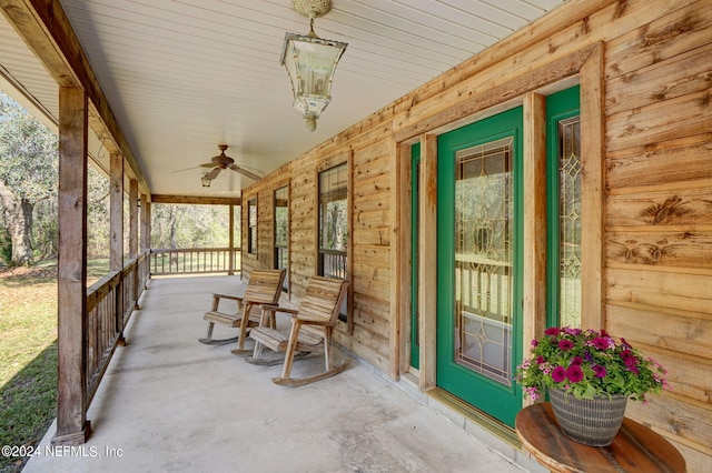 unfurnished sunroom featuring ceiling fan