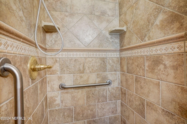 interior details featuring tiled shower