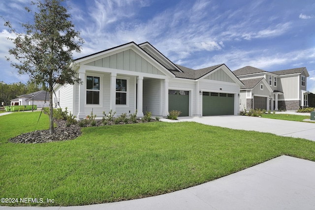 view of front of home featuring a front lawn, a porch, and a garage