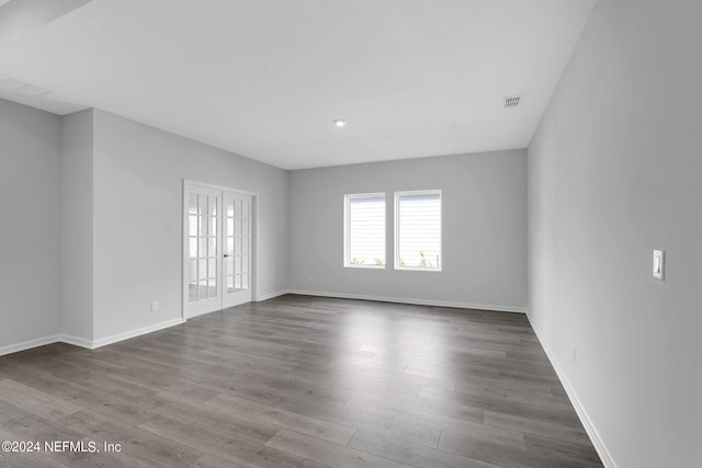 spare room with french doors and hardwood / wood-style flooring