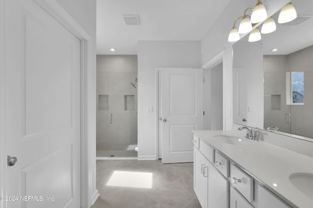 bathroom featuring tile patterned floors, vanity, and a shower with shower door