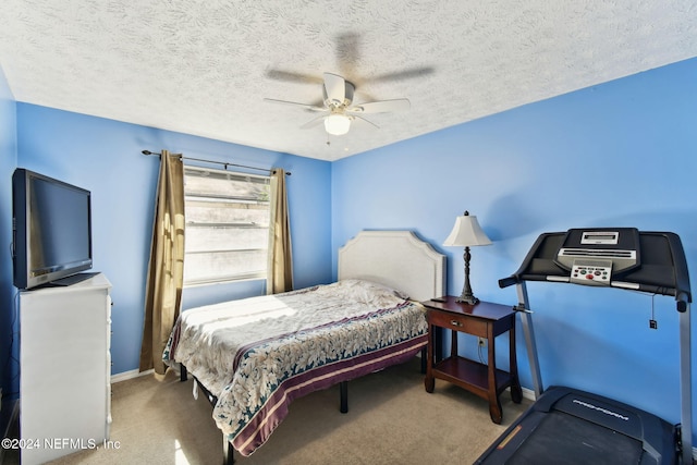 carpeted bedroom with ceiling fan and a textured ceiling