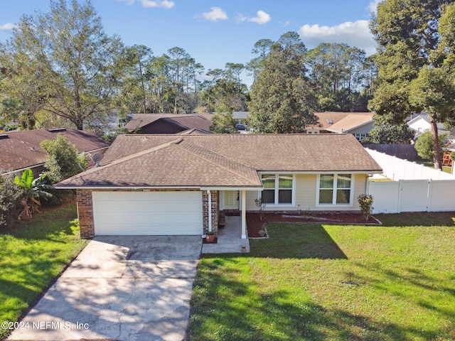 ranch-style house featuring a front yard and a garage