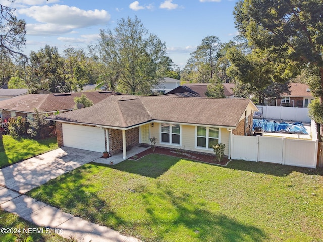 view of front of property featuring a front yard and a garage