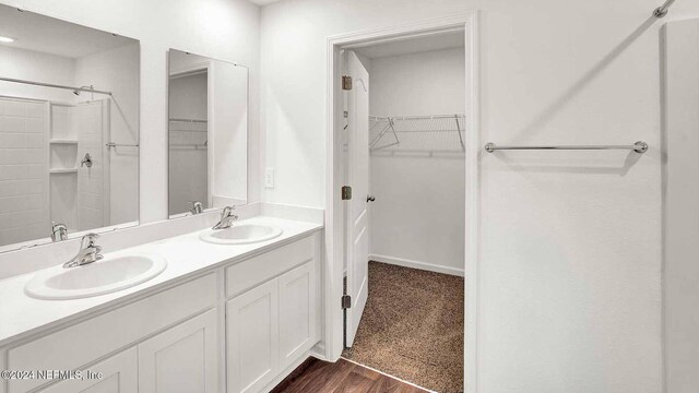 bathroom with vanity, a shower, and hardwood / wood-style flooring