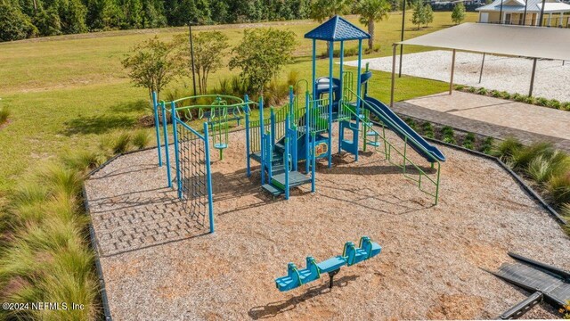 view of jungle gym featuring a lawn