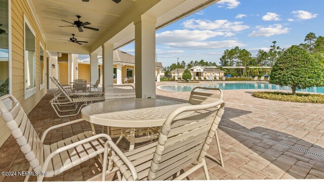 view of patio featuring a community pool and ceiling fan