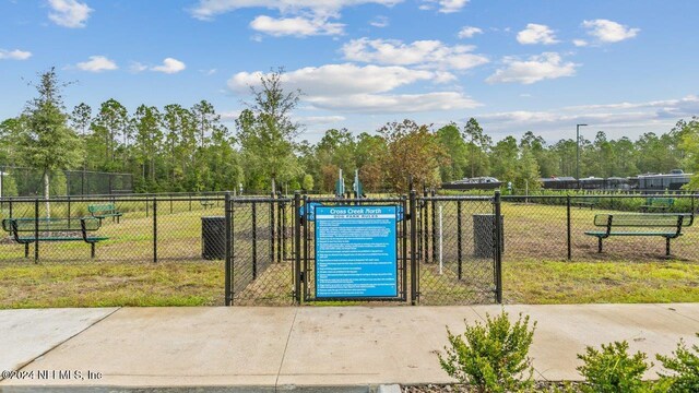 view of gate featuring a lawn