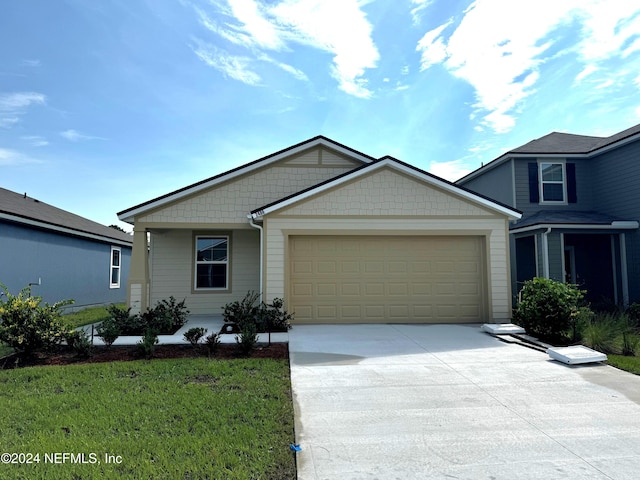 view of front facade with a front yard and a garage