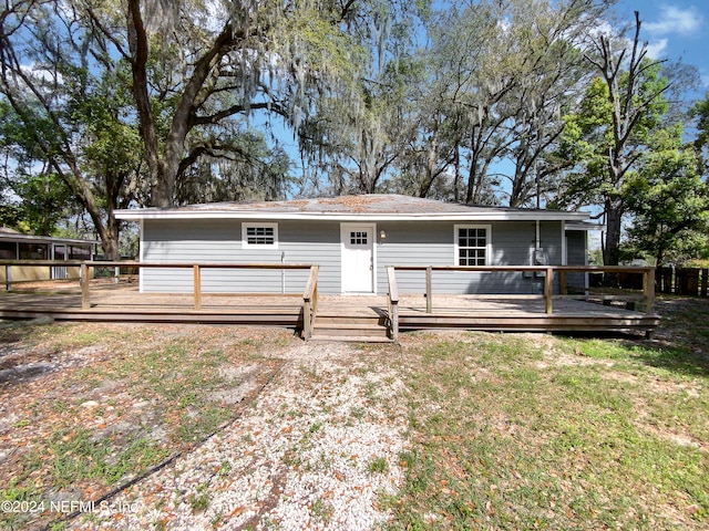 back of house featuring a wooden deck