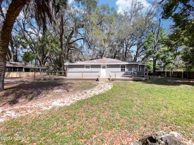 exterior space featuring a wooden deck and a yard