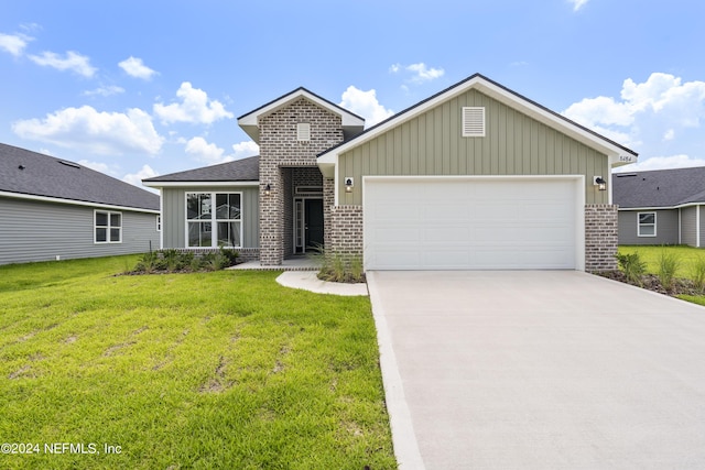 view of front of home with a front yard and a garage