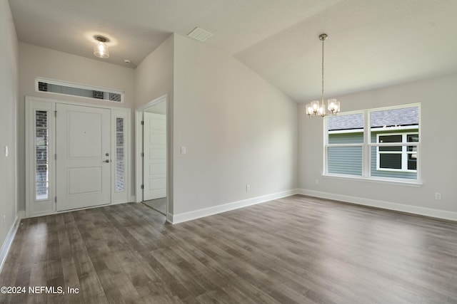 entrance foyer featuring a notable chandelier, dark hardwood / wood-style flooring, and lofted ceiling