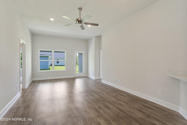 empty room featuring dark hardwood / wood-style floors and ceiling fan