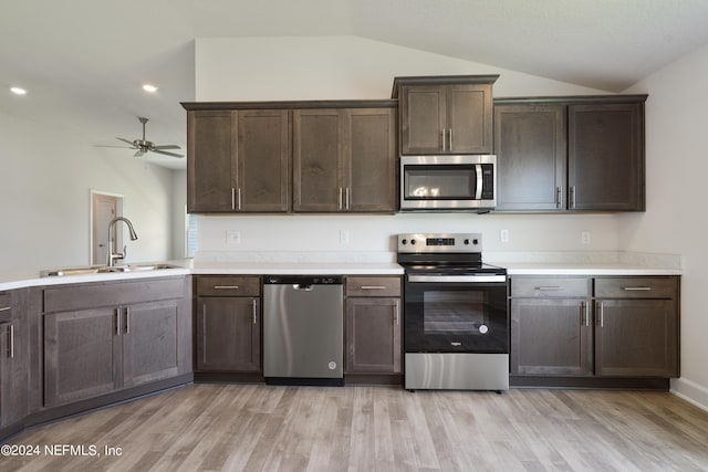 kitchen featuring stainless steel appliances, ceiling fan, sink, light hardwood / wood-style floors, and lofted ceiling