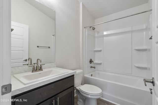 full bathroom featuring vanity, toilet, a textured ceiling, wood-type flooring, and tub / shower combination