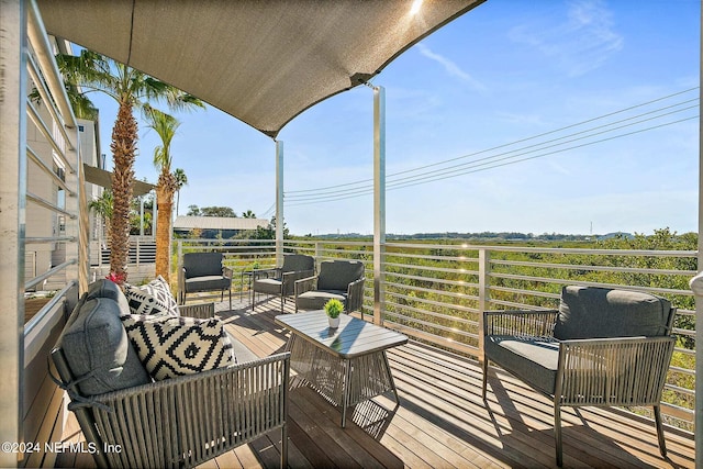 wooden terrace with an outdoor hangout area