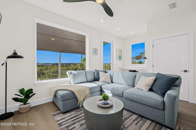 living room featuring wood-type flooring and ceiling fan