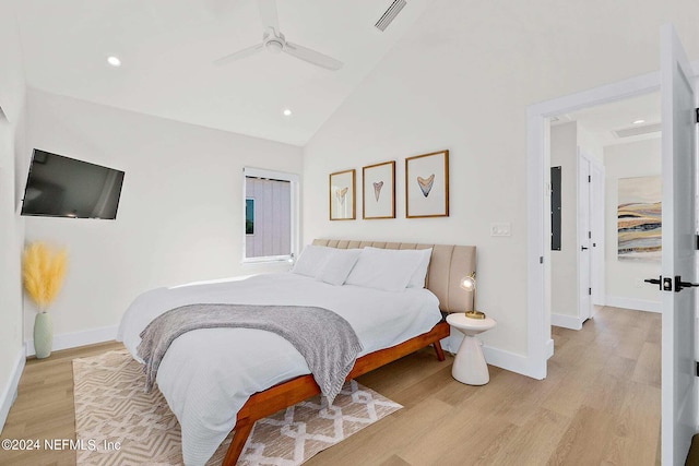 bedroom with high vaulted ceiling, ceiling fan, and light hardwood / wood-style flooring