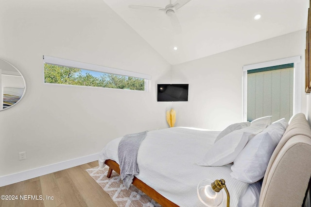 bedroom featuring light hardwood / wood-style floors, ceiling fan, and vaulted ceiling