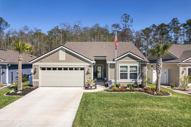 view of front of home featuring a front yard and a garage