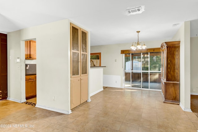 interior space featuring light tile patterned floors and an inviting chandelier